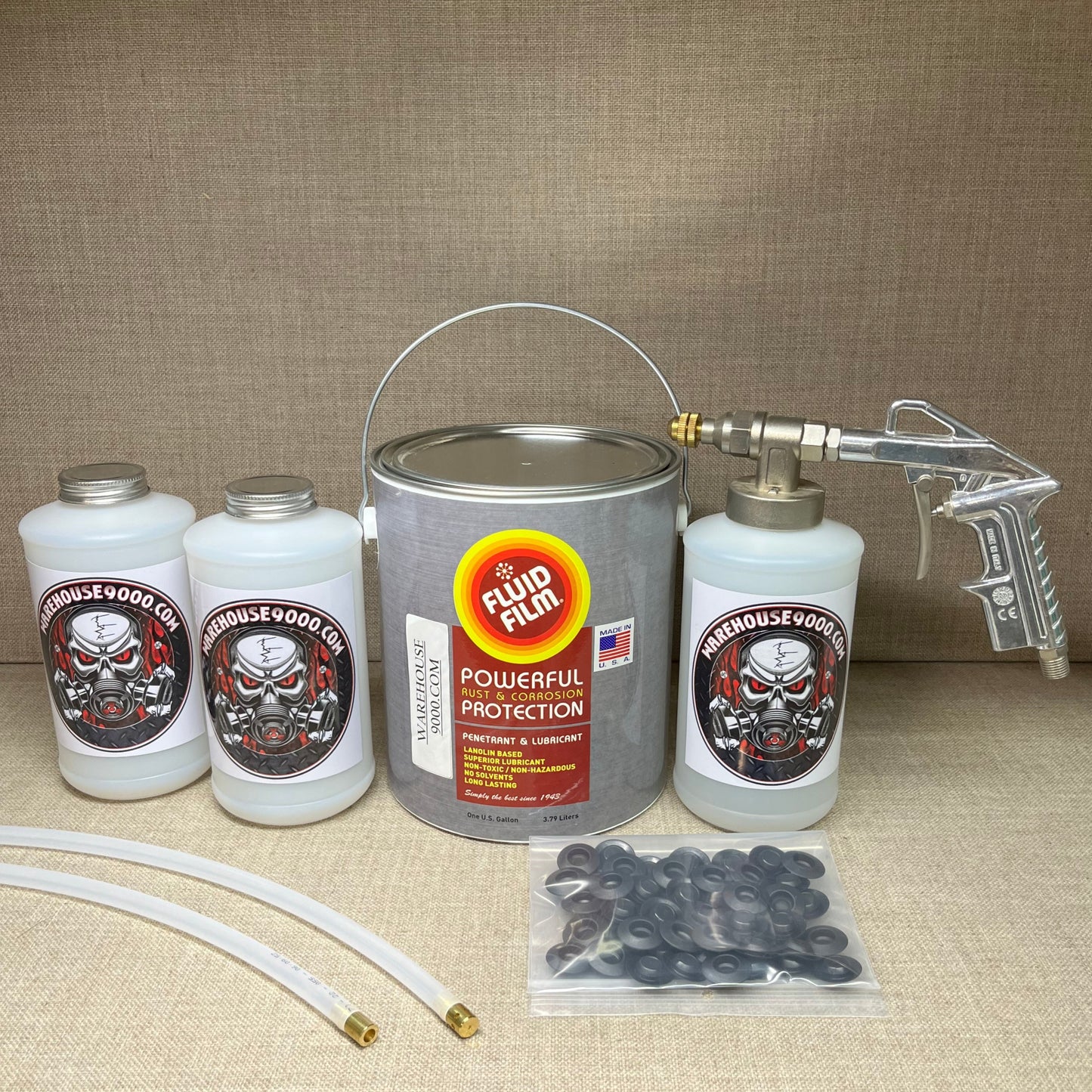 1 Gallon Fluid Film Amber, Pro Undercoating Spray Gun, 2 Spray Wands, 3 Quart Bottles, and 50 Rust Plugs